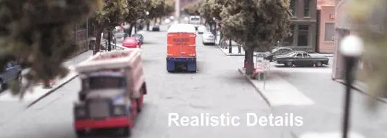 A truck driving down the street with traffic lights.