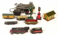 A bunch of toy trains and tracks are laying on the floor