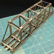 A metal bridge is sitting on top of a blue mat.