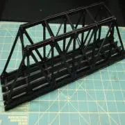 A black bridge is sitting on top of a blue paper.
