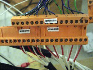 A bunch of wires that are connected to an orange box.