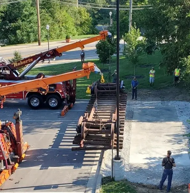 A crane is being lifted by a truck.