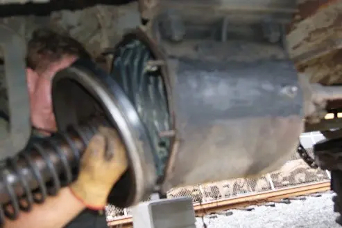 A person working on an engine of a car.