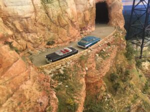 A model of two cars on the side of a mountain.